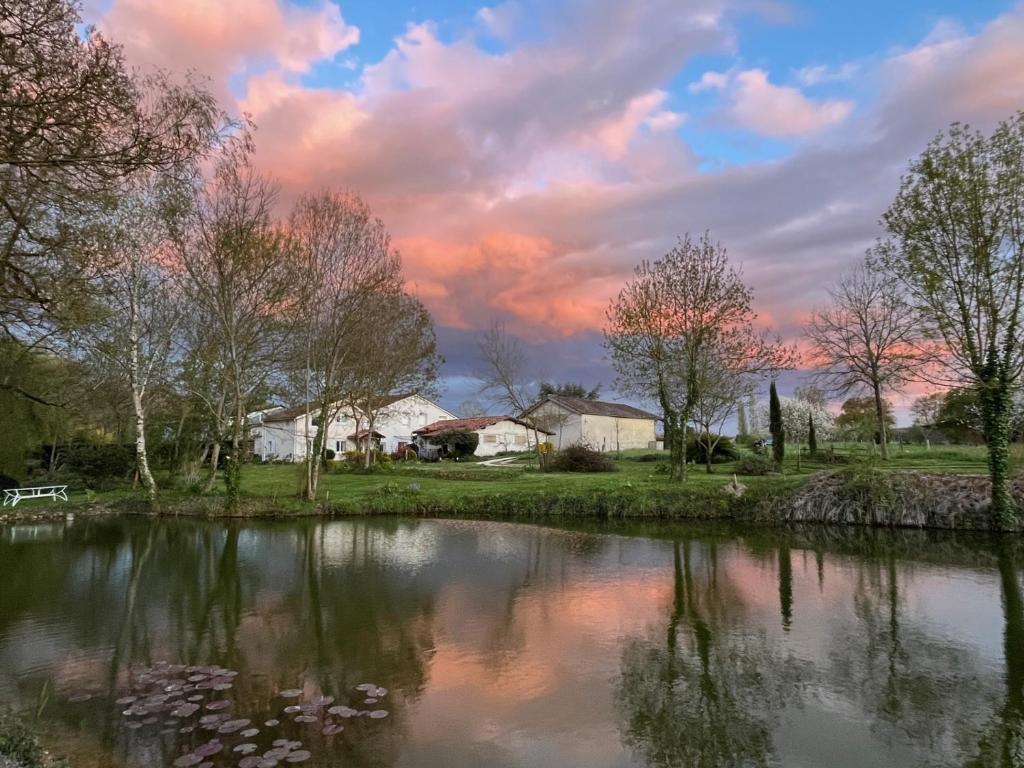 a view of a river with a cloudy sky at Les Chantours, Domaine naturel arboré et fleuri de15 hectares in Saint-Antoine-Cumond