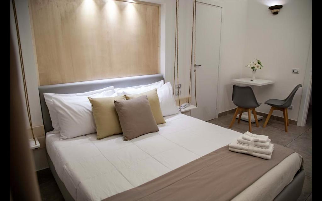 a bedroom with a large white bed with white pillows at Favorite Room&Spa in San Giuseppe Vesuviano