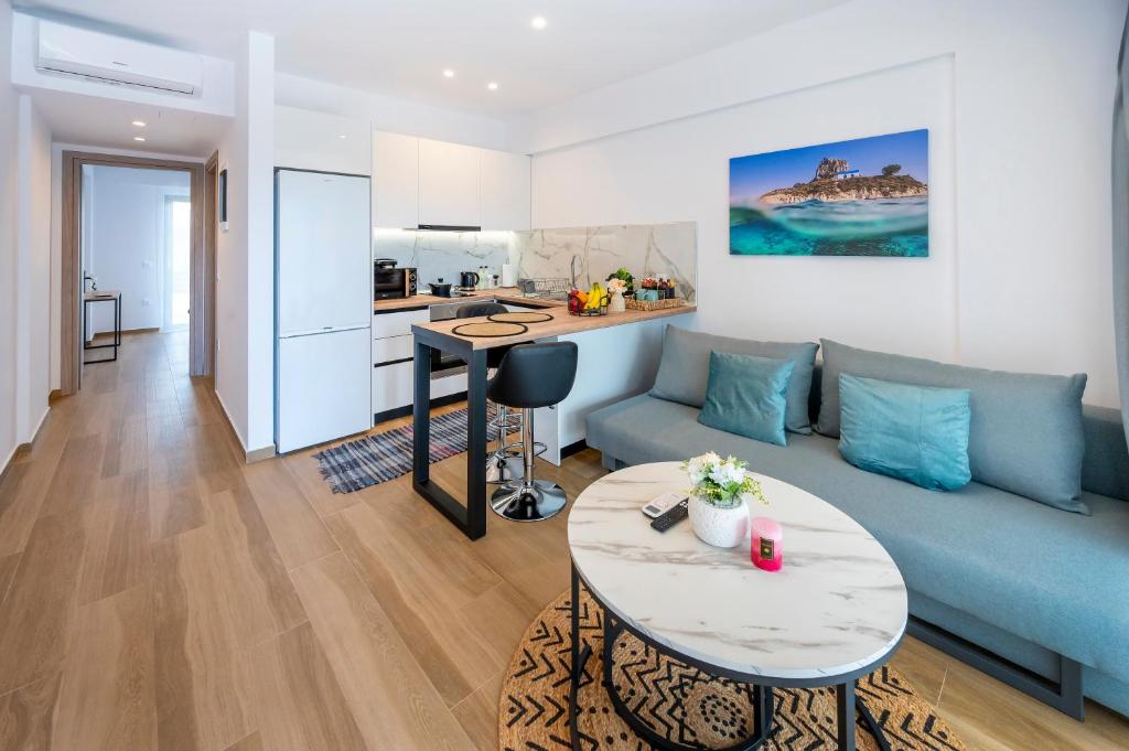 a living room with a blue couch and a table at Odaria Premium Apartments in Lampi