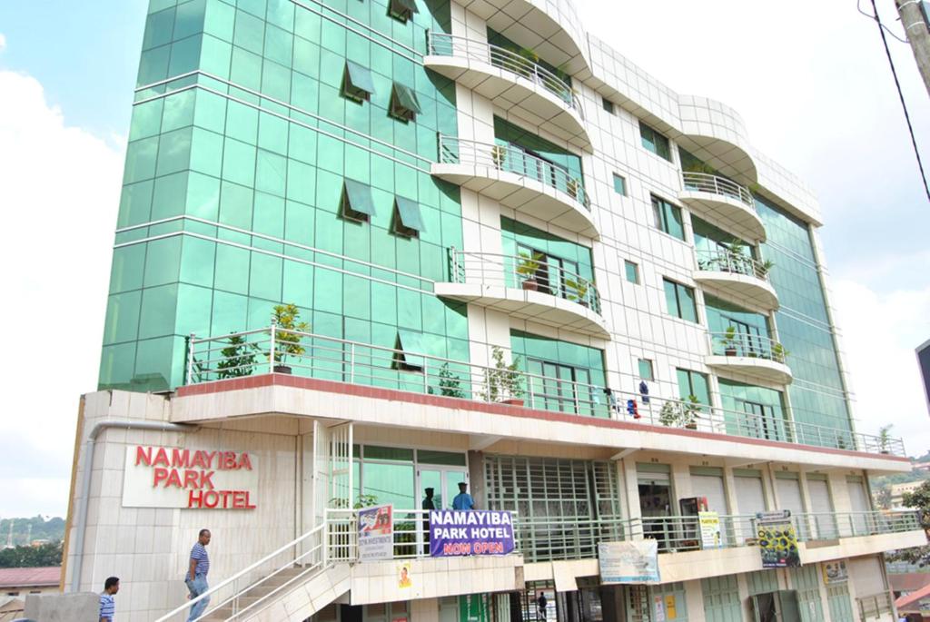 a tall building with people on the balconies of it at Namayiba Park Hotel Kampala in Kampala