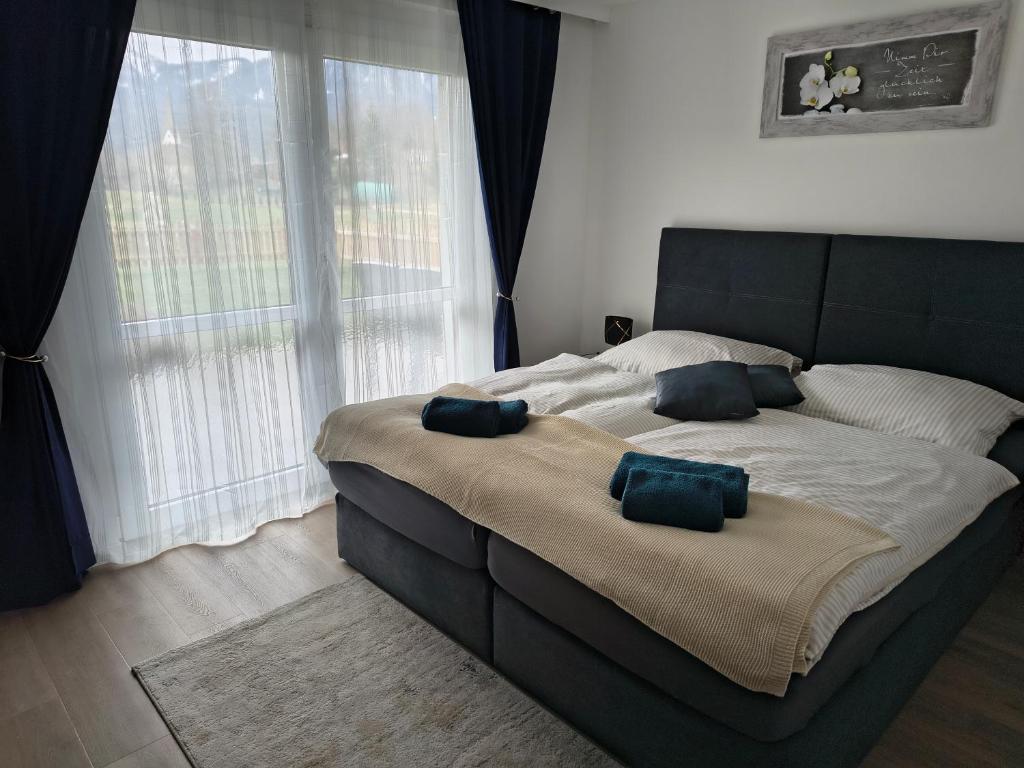 a bedroom with a large bed with two pillows on it at little lake Faakersee in Faak am See