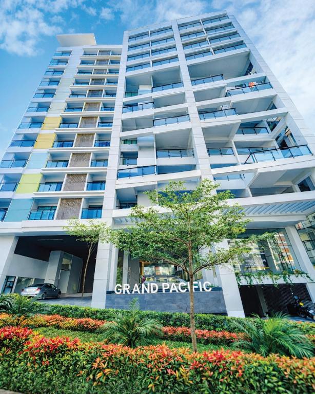 a tall white building with a sign on it at Hotel Grand Pacific in Cox's Bazar