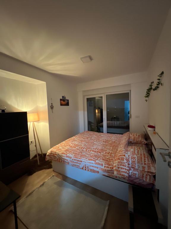 a bedroom with a bed and a television in it at Famely apartmen in Prizren