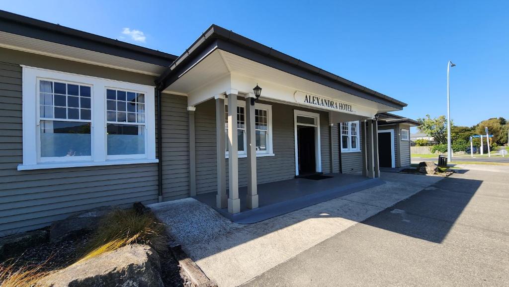 a building with a sign on the front of it at Alexandra Hotel in Pirongia