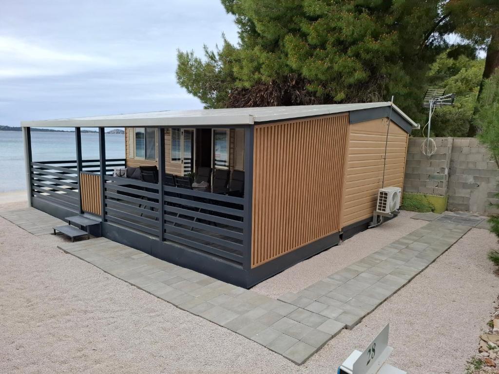 a building on the beach with the ocean in the background at Villa Petra 1 in Vodice
