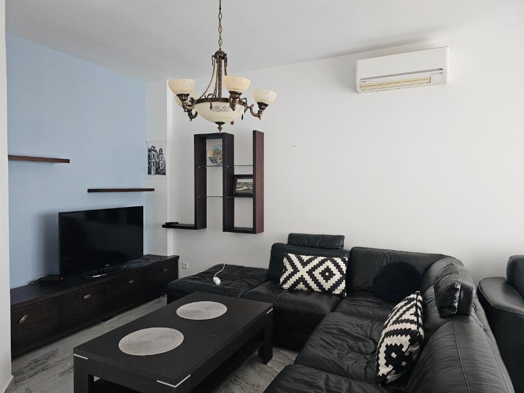 a living room with a couch and a tv at Apartment Pasha in Pržno