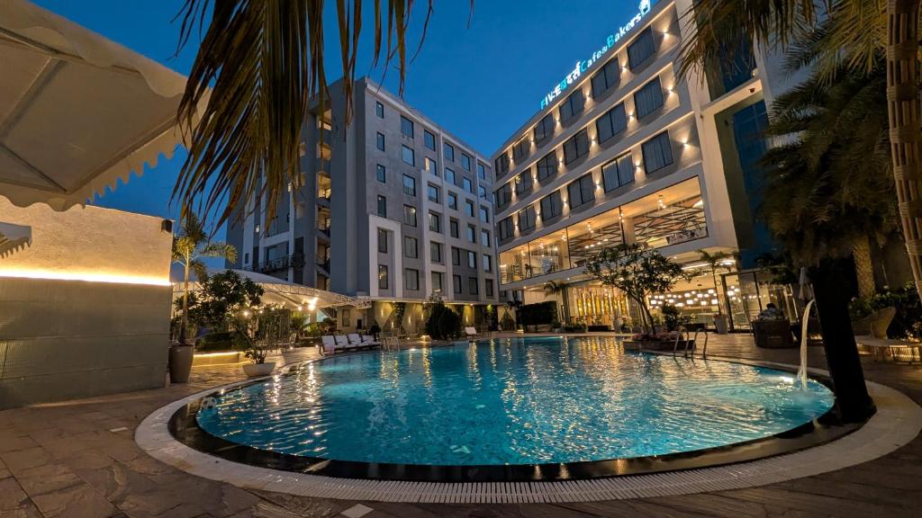 a large swimming pool in the middle of a building at Love Kush Hotel in Kishangarh