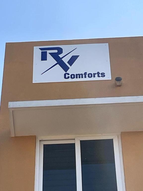 a sign on the top of a building with a k contracts sign at RV Comforts in Siruvāchchūr