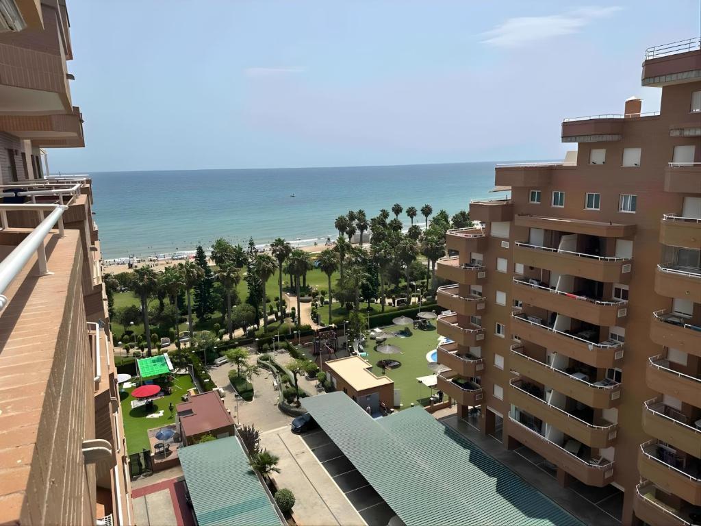 a view of the beach from the balcony of a building at Magic World Vistamar lll in El Borseral