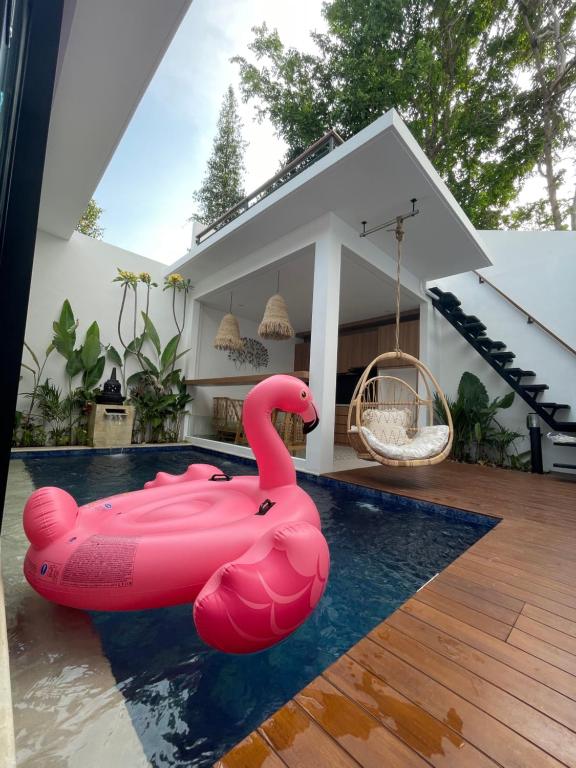 a pink inflatable flamingo in a pool in a house at Agarra Villa in Yogyakarta