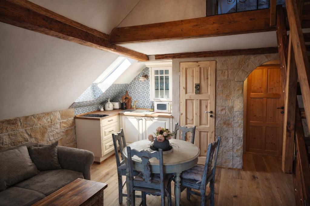 a kitchen and dining room with a table and chairs at Trapani house & camp in Růžová