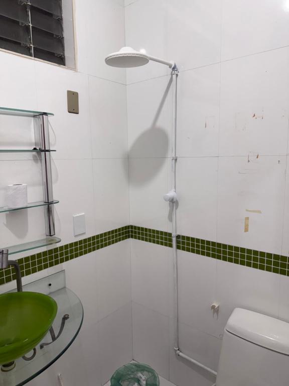 a bathroom with a shower and a green sink at Guest House da Amazônia in Manaus