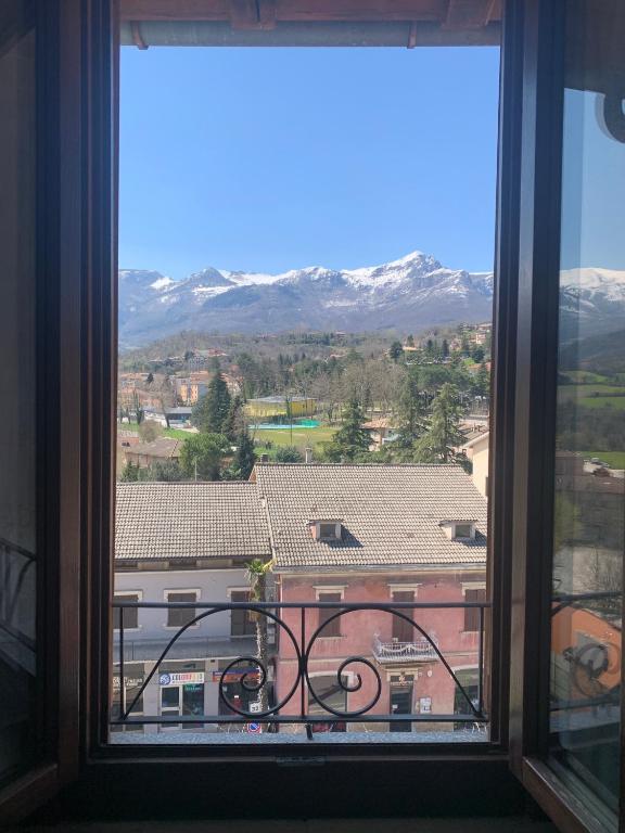 a window with a view of a city and mountains at Incanto dei sibillini- Piazza Perfetti 16 in Sarnano