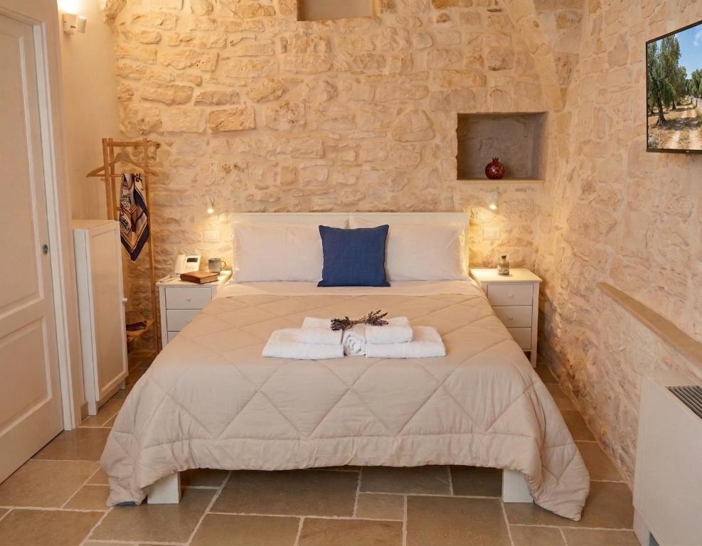 a bedroom with a bed with towels on it at Arcobaleno in Locorotondo