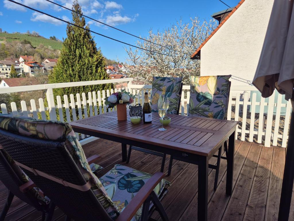 a wooden table and chairs on a deck at Rebenhaus St Martin in Sankt Martin