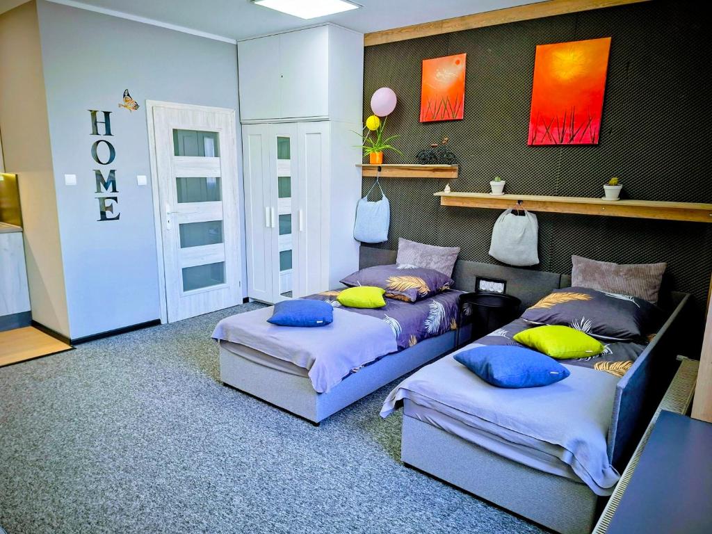 a room with two beds with pillows on them at Apartament Na Reymonta in Starogard Gdański