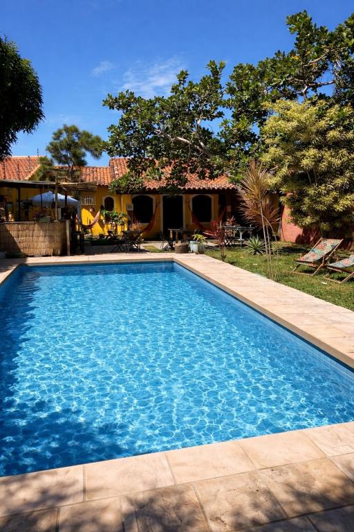 a swimming pool in front of a house at Chill House Buzios in Búzios