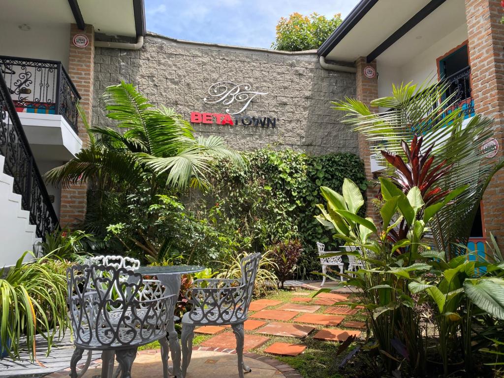 a patio with chairs and plants in front of a building at Beta Hotel in Salento