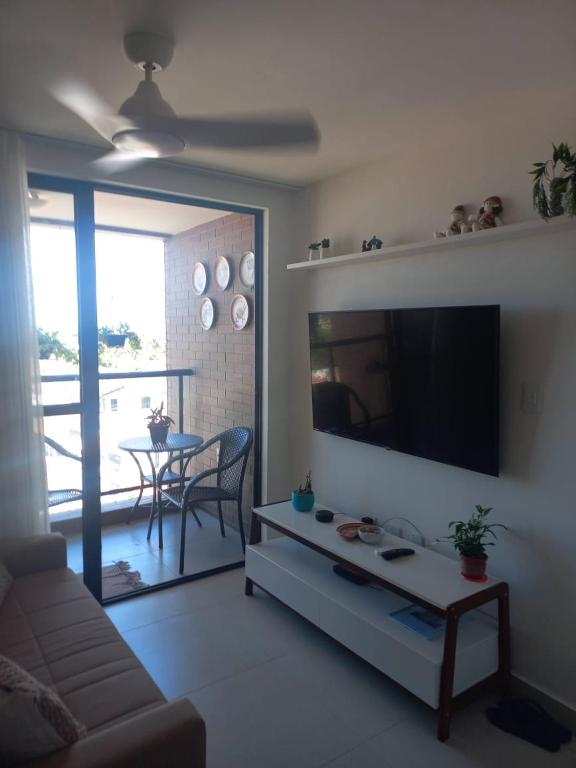 a living room with a couch and a flat screen tv at Villas House - Praia Formosa - Cabedelo in Cabedelo