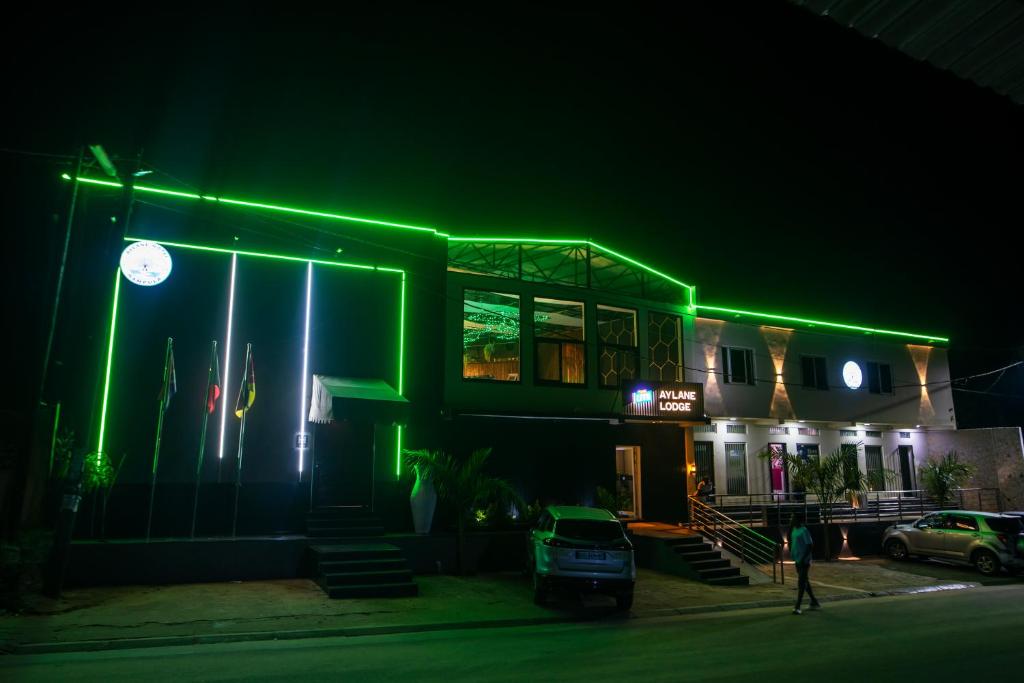 a building with green lights on it at night at Aylane Hotel in Nampula