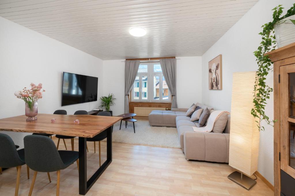 a living room with a table and a couch at Apartment Troya in Unterseen