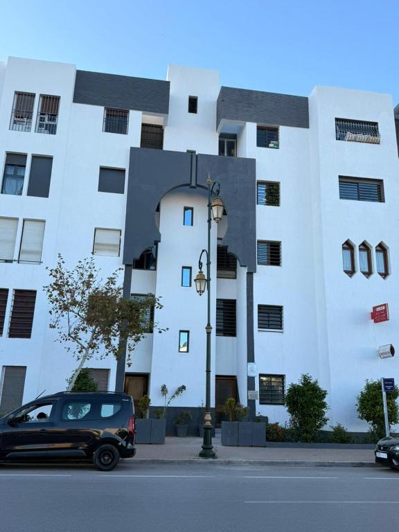 a black car parked in front of a building at Cozy Central Nahda in Rabat