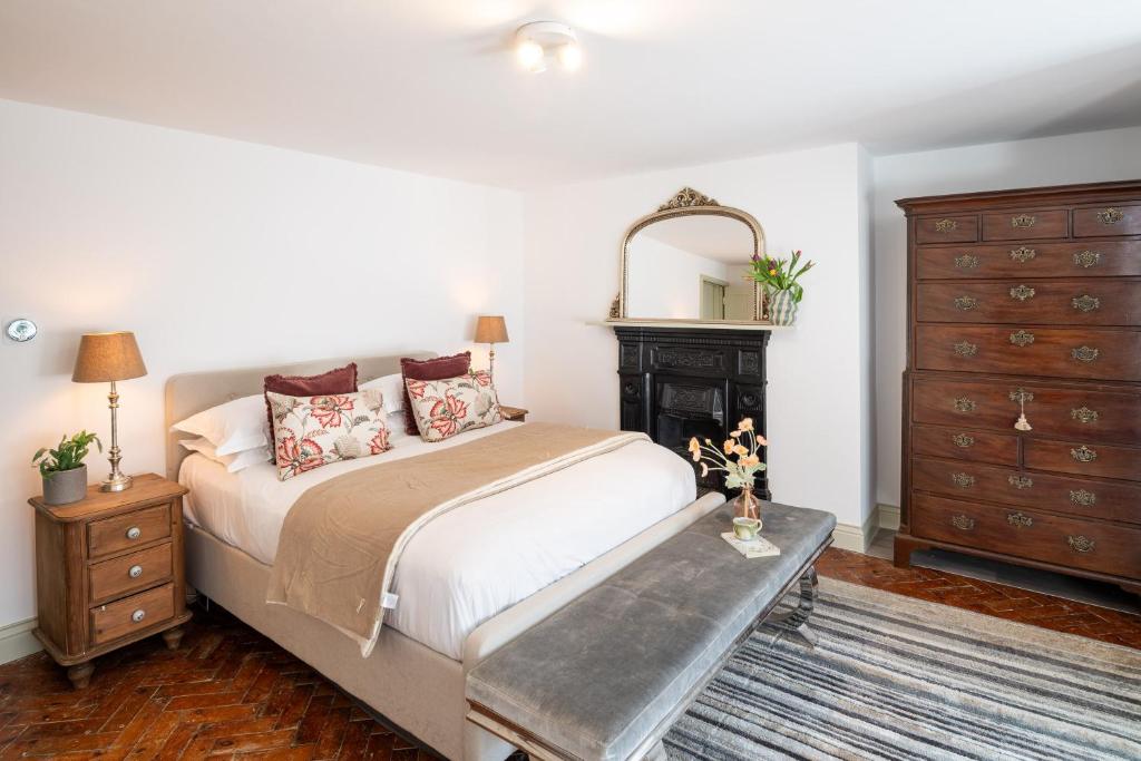 a bedroom with a bed with a fireplace and a dresser at Modern Flat on the seafront Exmouth in Exmouth
