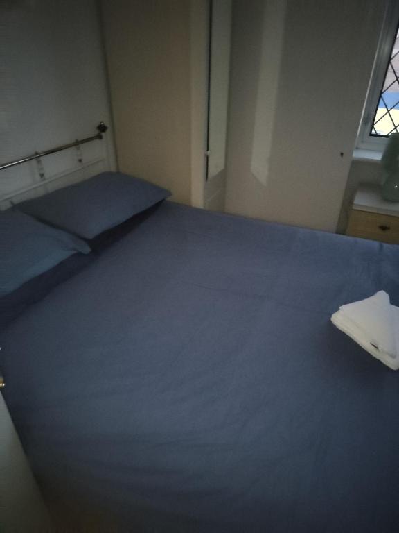 a room with a large bed with a keyboard on it at Cristabel Guest House in Clacton-on-Sea