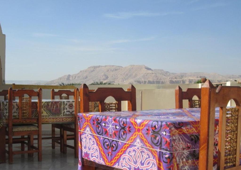 a table and chairs with a colorful table cloth on it at Kareem Hotel Luxor in Luxor