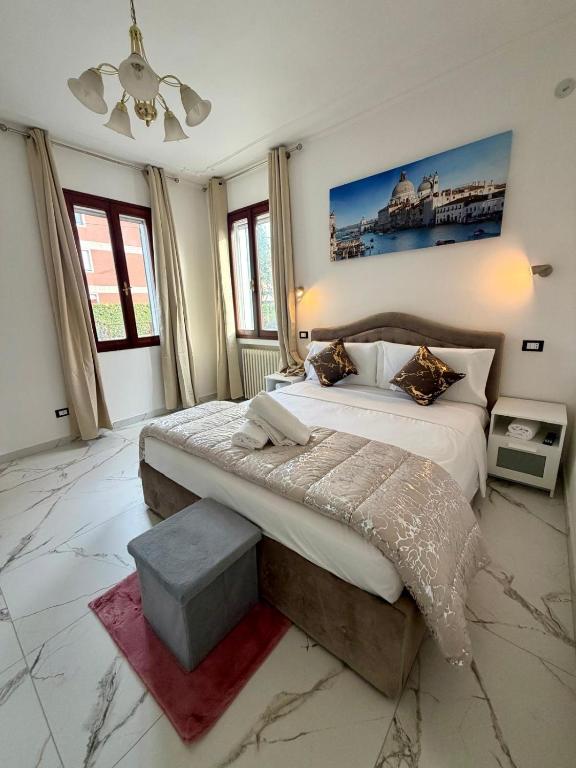 a bedroom with a large bed and a painting on the wall at Venice Star Villa in Mestre