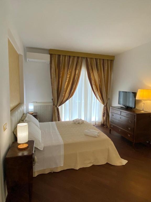 a bedroom with a large bed and a window at Sparano 51 in Bari