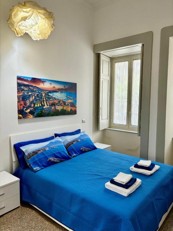 a bedroom with a blue bed with towels on it at Villa Iside Casavacanze in Gragnano