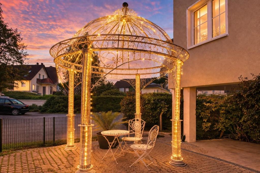 a gazebo with a table and chairs in front of a house at Villa Manatee mit Sauna & Fitness in Ostseebad Sellin