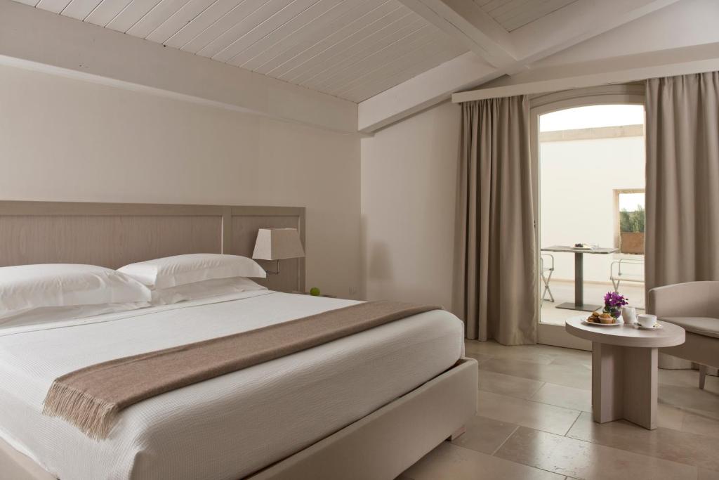 Posteľ alebo postele v izbe v ubytovaní Relais Histò San Pietro Sul Mar Piccolo