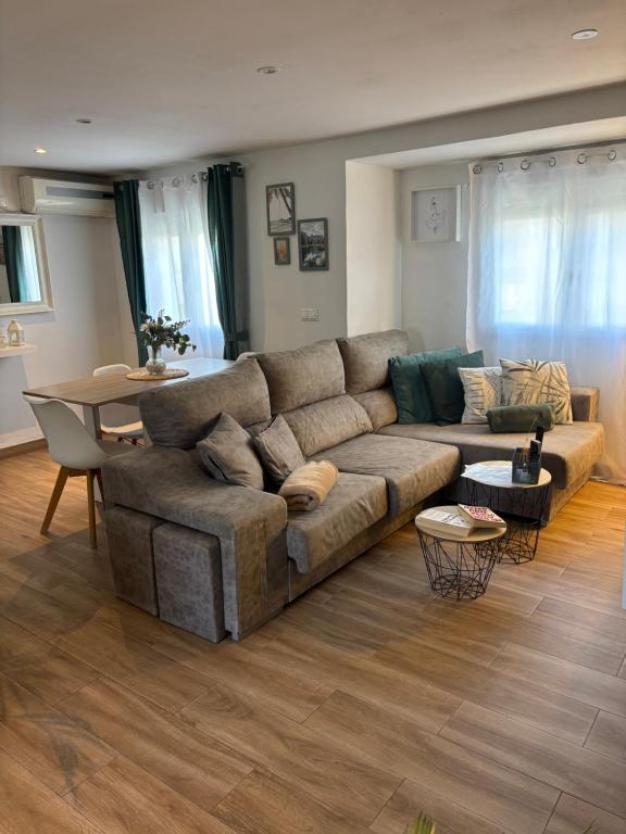 a living room with a couch and a table at Tu hogar en Sevilla in Seville