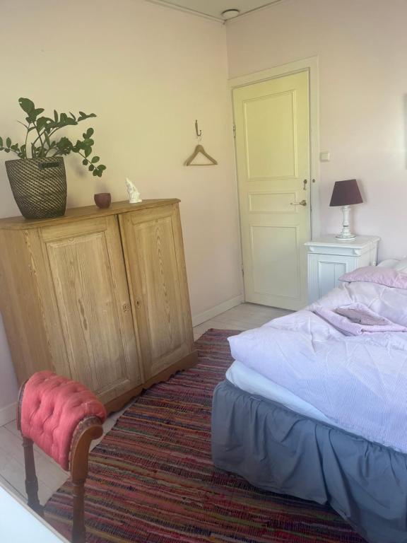 a bedroom with a bed and a potted plant at På landet nära stan in Stockholm