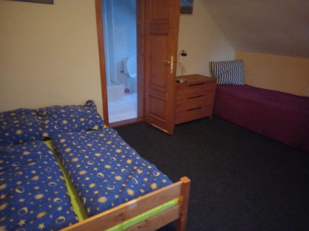a bedroom with a bed and a dresser and a mirror at Kutloch u Trpoše in Pernink