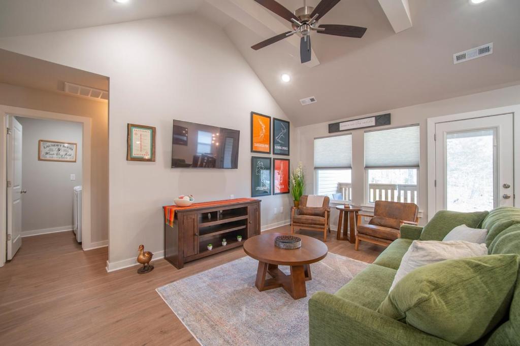 a living room with a couch and a table at Back 40 Homestead - Trailside Basecamp in Bella Vista