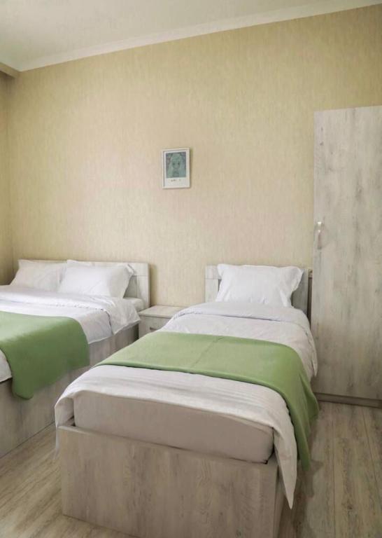 two beds in a small room with at Hotel Blue sky in Tbilisi City