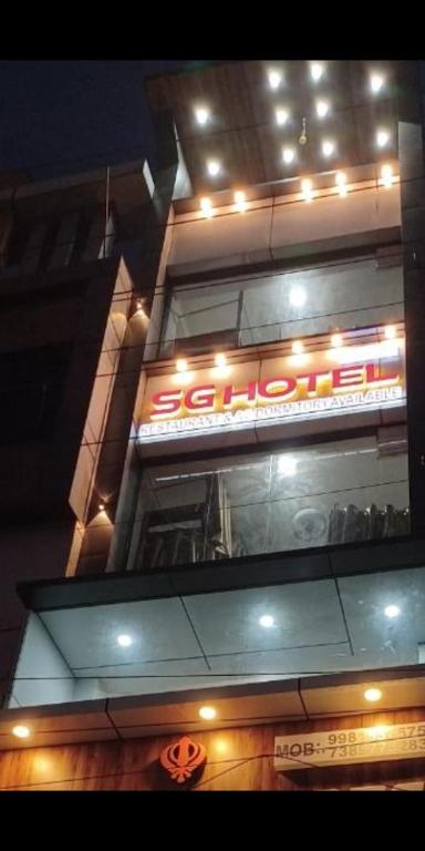a building with a sign on top of it at night at Sg hotel in Bhopal