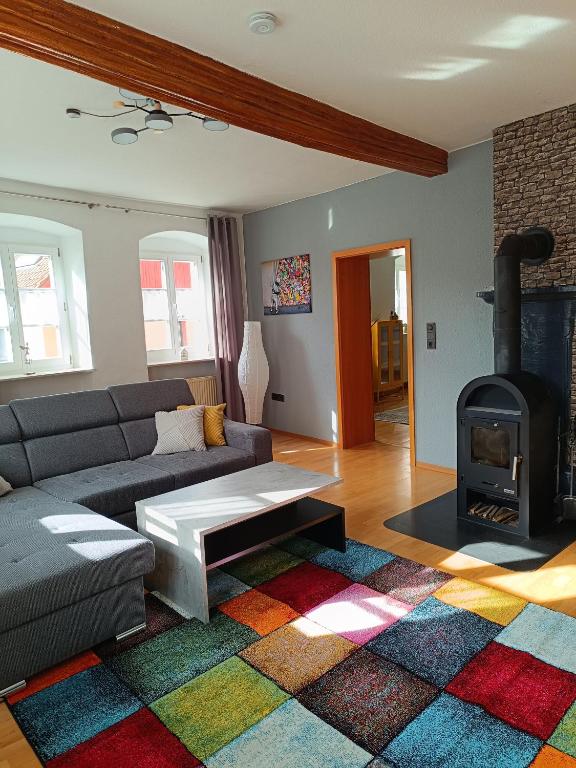 a living room with a couch and a fireplace at Ferienwohnung am Kloster in Hornbach