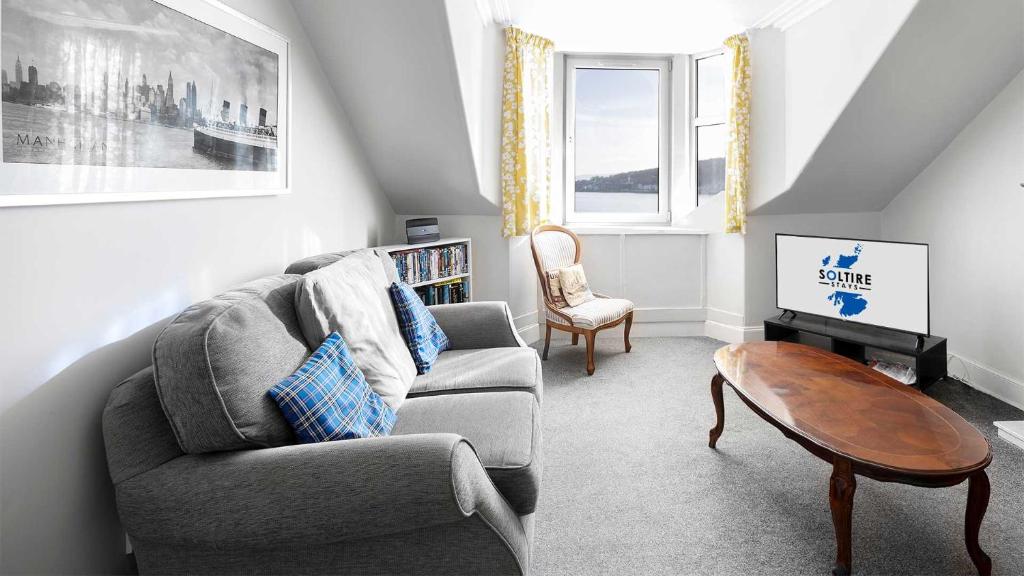 a living room with a couch and a coffee table at Bute Seaview in Rothesay