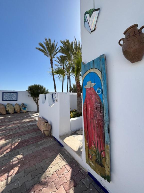 a painting of a woman on the wall of a building at Jardins de Mezraya in Mezraya
