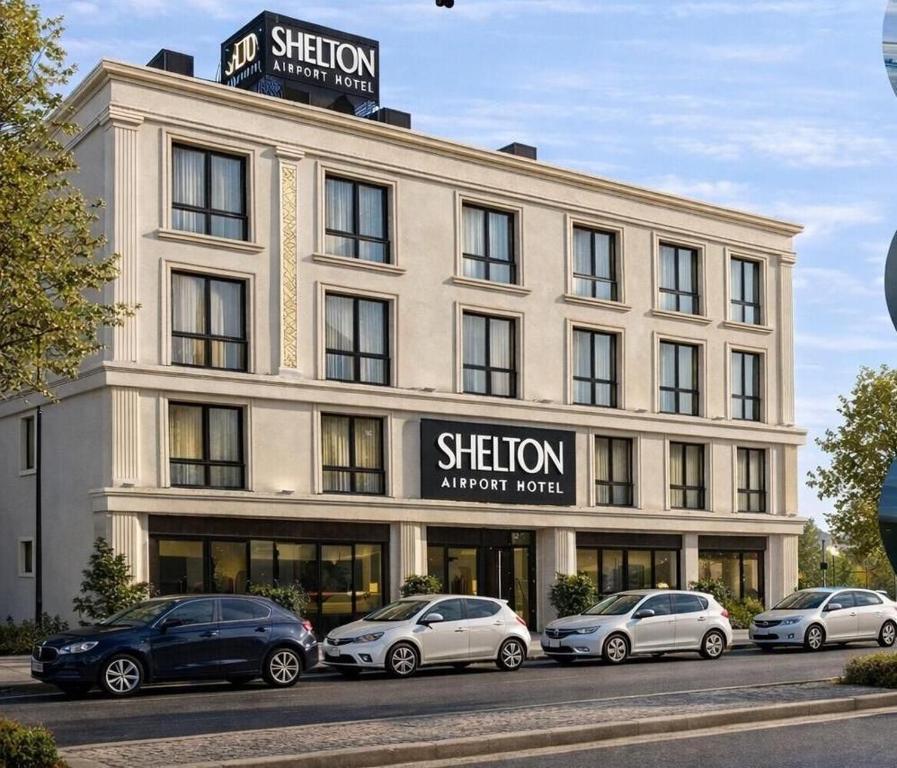 a building with cars parked in front of it at Shelton Airport Hotel in Arnavutköy