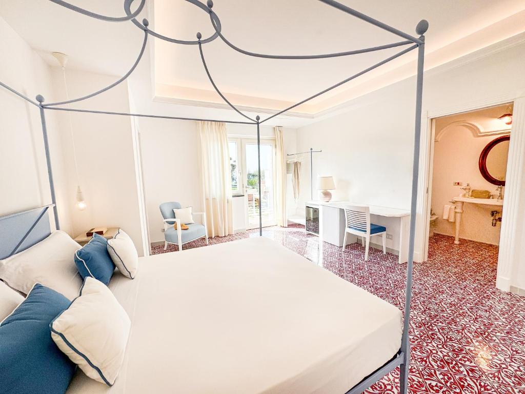 a bedroom with a bed and a desk at Amira Capri in Anacapri