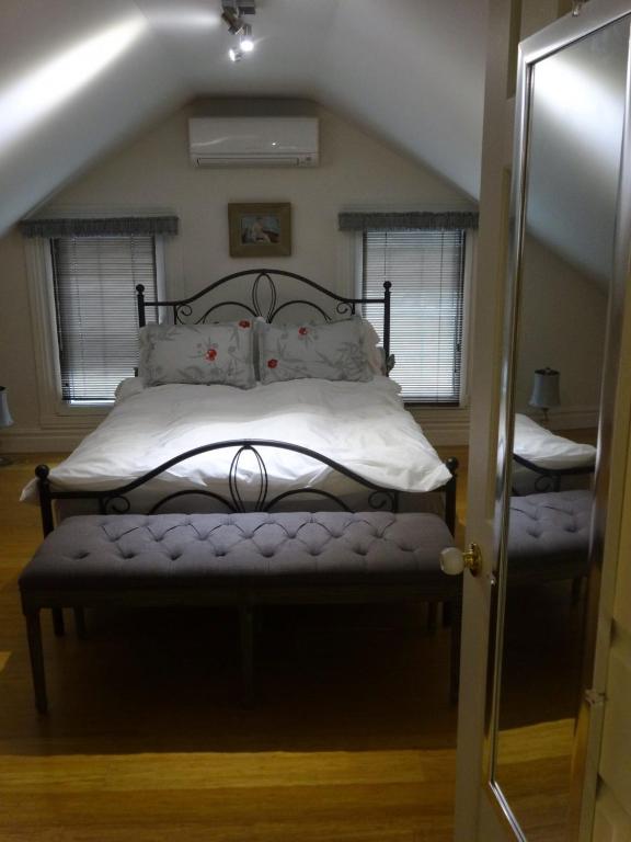 a bedroom with a bed in a attic at villa du vignoble in Dunham