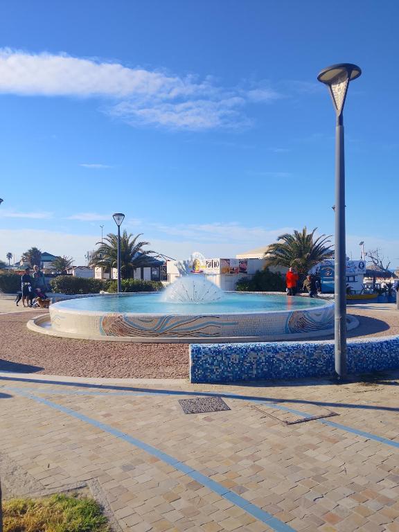 a fountain in a park with a street light at Il sorriso romagnolo in Misano Adriatico
