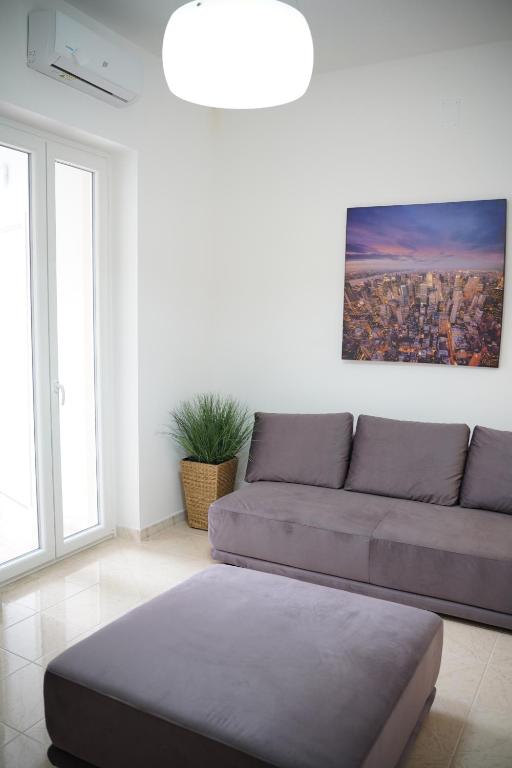 a living room with a couch and a painting at Giocca Rooms in Palagiano