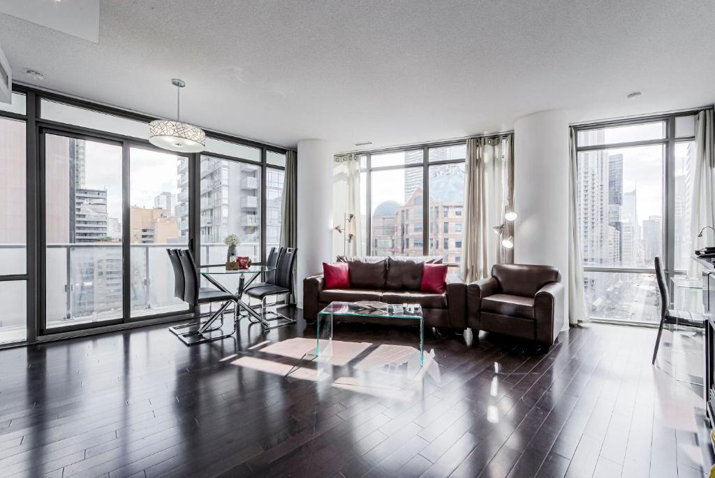 a living room with a couch and a table at Adelaide Stays and Suites - Walk to Subway - Easy Access Downtown Toronto in Vaughan