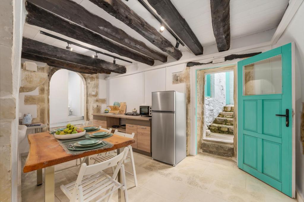 a kitchen with a table and a refrigerator at Villa Amanda by CVR in Roústika